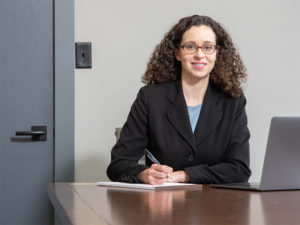 Image of Elise Putnam at her desk in her office in downtown Asheville