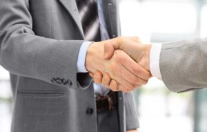 Image of two men shaking hands in agreement.