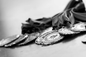 Black and white image of Olympic medals representative of awards.