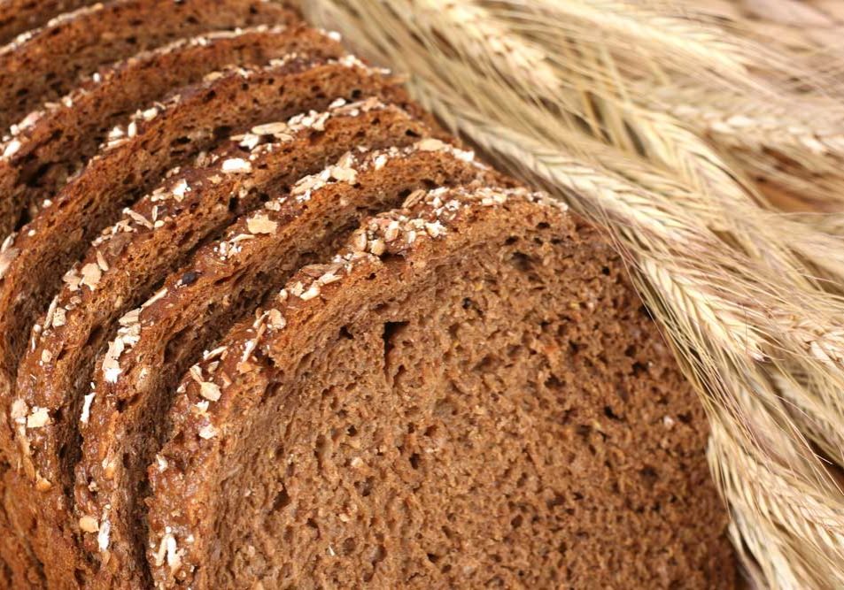 Breadwinner Image of sliced brown bread with stalks of wheat referencing the idea of a "breadwinner".