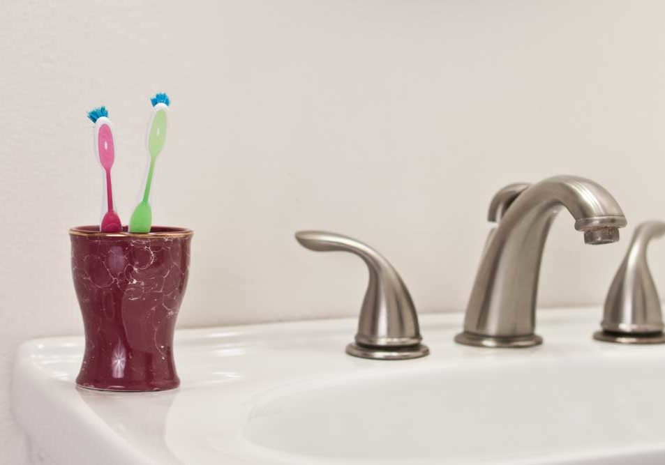 Cohabitation Image of two toothbrushes on a bathroom sink depicting living together