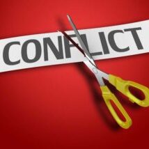 Image of the word CONFLICT on a red background being cut by a scissor.