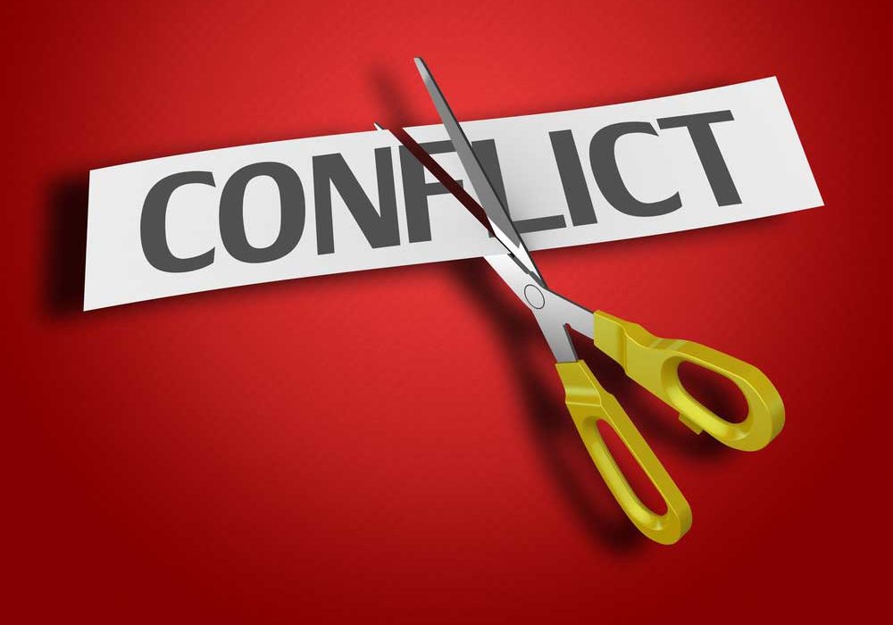 Cutting Conflict Image of the word CONFLICT on a red background being cut by a scissor.