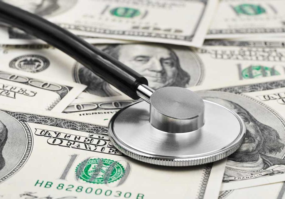 Divorce and Financial Health A pile of money with a stethoscope depicting monitoring of financial health.