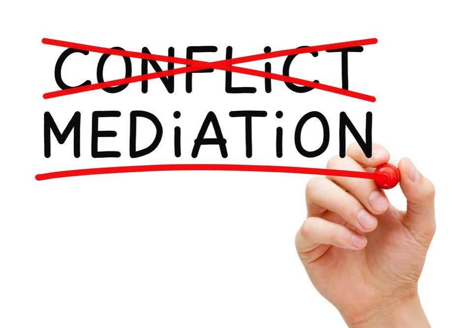Conflict Resoluton Conflict Resolution image depicting the words "conflict" and "mediation" on a glass board. Person with red marker has crossed out "conflict" and is underling mediation.