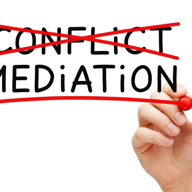 Conflict Resolution image depicting the words "conflict" and "mediation" on a glass board. Person with red marker has crossed out "conflict" and is underling mediation.