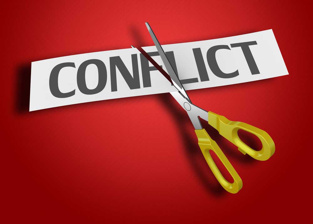 Image of the word CONFLICT on a red background being cut by a scissor.