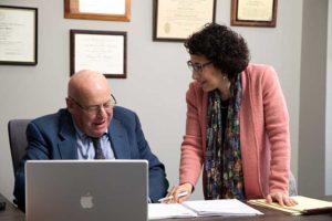 Image of David R. Hillier and his paralegal Idelle Davids discussing documents.