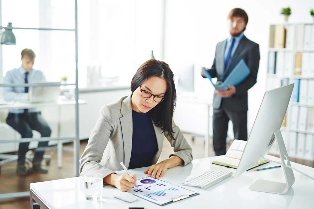 Image of a competent business woman analyzing graphs depicting the kind of investigative and analytic services provided by experts in divorce matters.