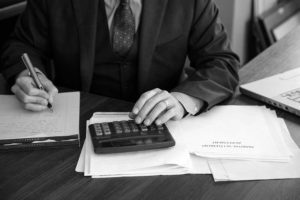 Image of Patrick McCroskey working on the financial parts of a settlement agreement.