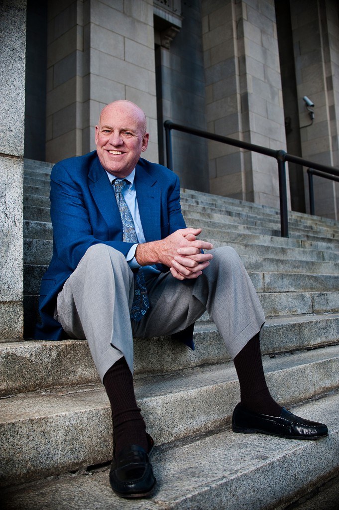 Dave Hillier sitting on the granite stairs in front of the Federal Courthouse in Downtown Asheville (United States District Court for the Western District of North Carolina, where Bankruptcy Court is housed)