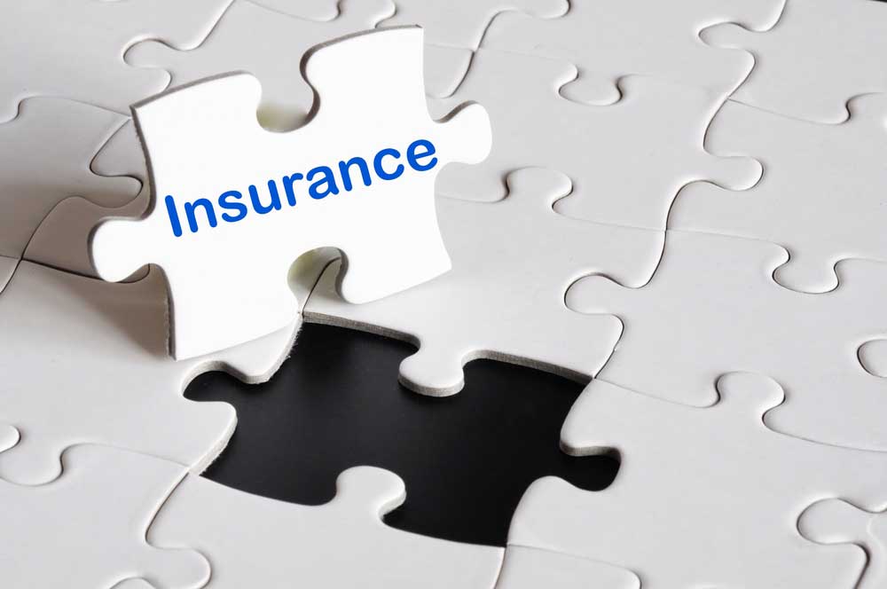 A white puzzle with one missing piece labeled insurance suggesting that insurance is a part of the puzzle