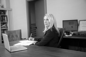 Black and white image of Janet Amburgey in her office in downtown Asheville.