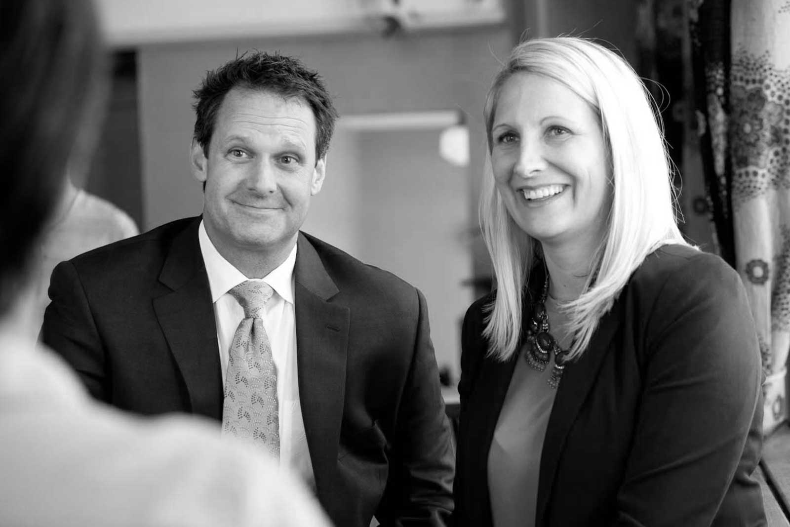 janet-patrick-downtown Black and white image of attorneys Patrick McCroskey and Janet Amburgey meeting with a client.