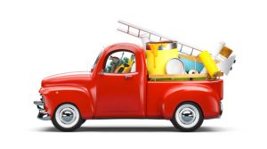 Image of a toy, possibly a model, of a bright red antique truck filled with colorful tools depicting the idea of property belonging to a family that might be titled by a business or third party