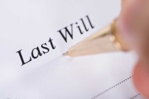 Image of formal "Last Will" document with pen.