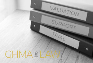Image of notebooks on a desk labeled Valuation, Support & Trial, denoting organization and preparedness for trial of matters that could not be settled at Mediation.