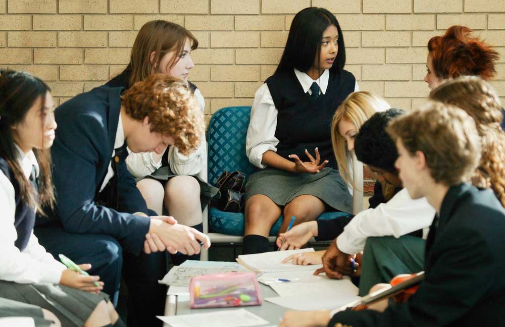 Image of a group of private school students wearing school uniforms in a study session.